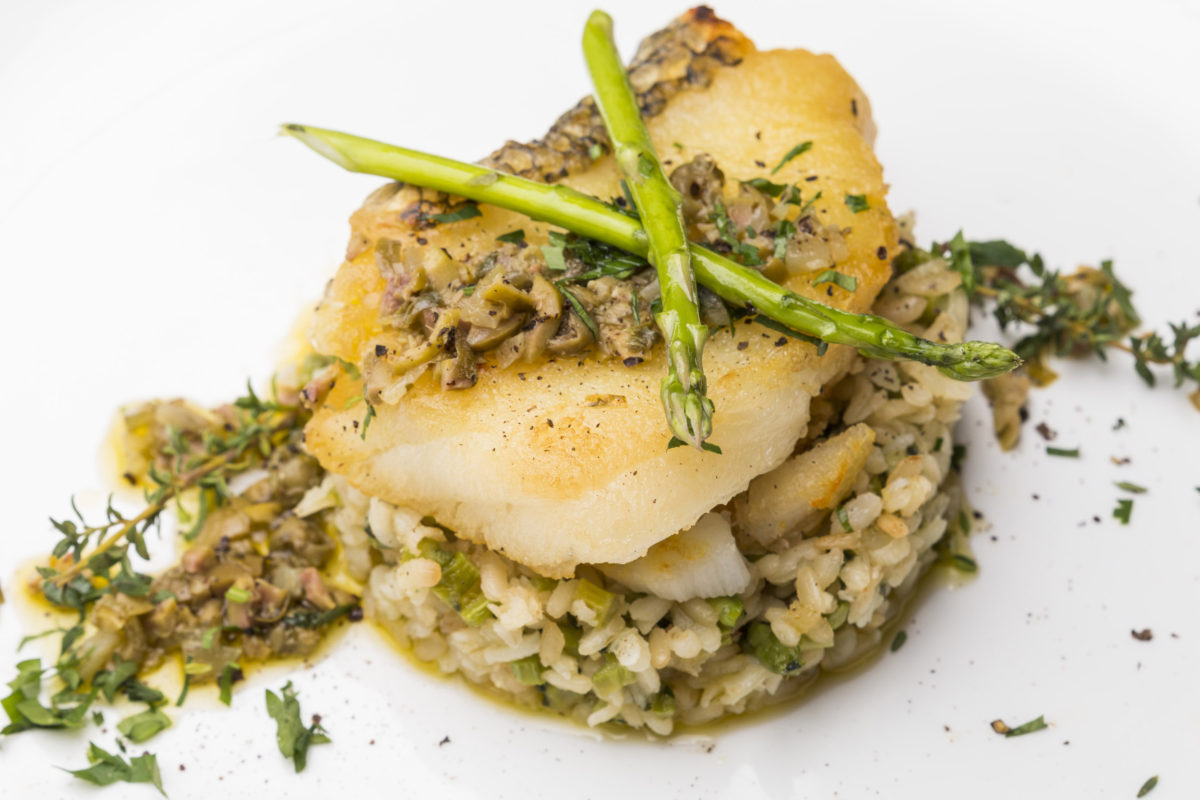 Food Photography - Italian Cuisine - Grilled Fish on a bed of Risotto with Asparagus